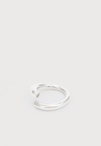 Anillo abierto de plata con un diseño suave y redondeado. Presenta un logo sutil en un extremo y un acabado pulido, que exhibe un aspecto elegante y moderno.