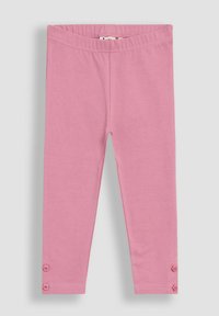 Rózsaszín gyerek leggings elasztikus derékkal és két kis díszgombbal minden bokánál, laposan elhelyezve egy szürke háttéren.