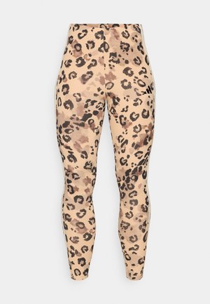 Legging en imprimé léopard avec un mélange de teintes beiges et marron, texture lisse et taille élastique pour un confort optimal.