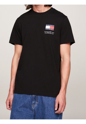 Black cotton t-shirt featuring a small logo in red, white, and blue on the left chest area. Short sleeves and crew neck design.