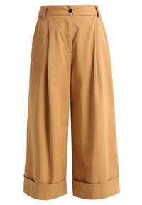 Vida byxor i ljusbrun bomull. Har hög midja, veck framtill och uppvikta fållar vid bensluten.