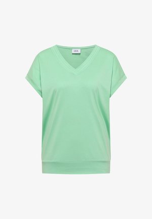 Top de manga corta y escote en V de color verde claro con un dobladillo ancho y una etiqueta cosida en el interior del escote que dice "CECIL."