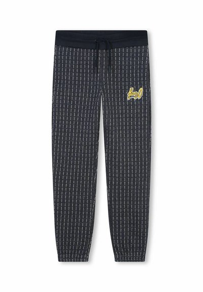 Des joggings bleu marine présentent un motif rayé vertical, une taille élastique avec cordon de serrage, et un logo brodé jaune sur la cuisse.