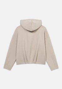 Μπεζ cropped φούτερ με απαλή υφή, κουκούλα με κορδόνι και μακριά μανίκια. Η ραφή στην πλάτη προσθέτει οπτικό ενδιαφέρον.