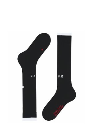 Par de calcetines negros hasta la rodilla con ribete blanco en la parte superior y letras blancas "KE" en la pantorrilla, texto rojo en el pie y un pequeño símbolo rojo en la suela.