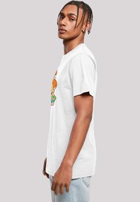 White cotton t-shirt featuring a colorful cartoon graphic on the front. Short sleeves and a relaxed fit. Classic crew neckline.
