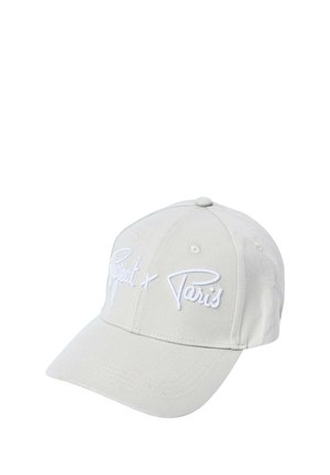 Casquette de baseball beige clair avec une visière incurvée et un texte blanc brodé indiquant « Project x Paris » sur le panneau avant.