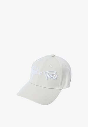 Casquette de baseball beige clair avec une visière incurvée et un texte blanc brodé indiquant « Project x Paris » sur le panneau avant.