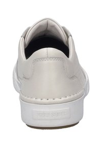 White leather sneaker with a textured, padded heel tab and logo on the back. The sole is white rubber, providing a contrasting edge.