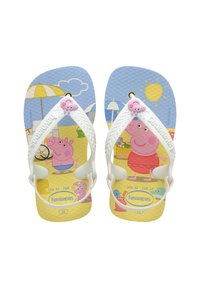 Des tongs pour enfants avec un motif bleu et jaune représentant des cochons de bande dessinée, des brides blanches et des semelles texturées. Marque Havaianas visible.