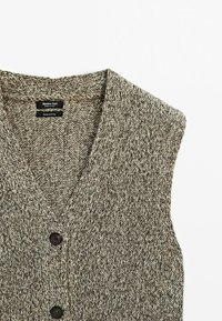 Gilet sans manches tricoté marron et beige avec col en V et deux boutons foncés, en 100 % coton de Massimo Dutti.