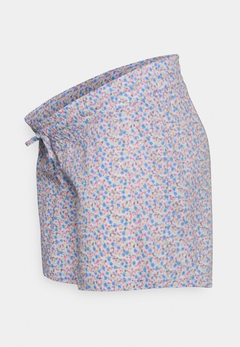 Jupe de grossesse de couleur claire avec un petit motif floral bleu, rose et violet et une ceinture nouée, vue de côté.