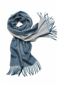Soft, blended wool scarf featuring a gradient of dark blue and grey, with fringed edges. Lightweight and textured fabric drapes elegantly.