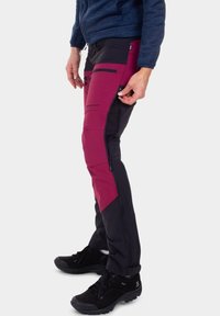 Men's outdoor pants with a mixed design of maroon and black fabric. Features zippered pockets and reinforced knees for durability.