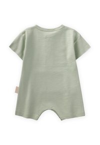 Tuta a maniche corte in morbido cotone verde chiaro, con scollo rotondo e un'etichetta di lato, dal fit rilassato e gambe corte.