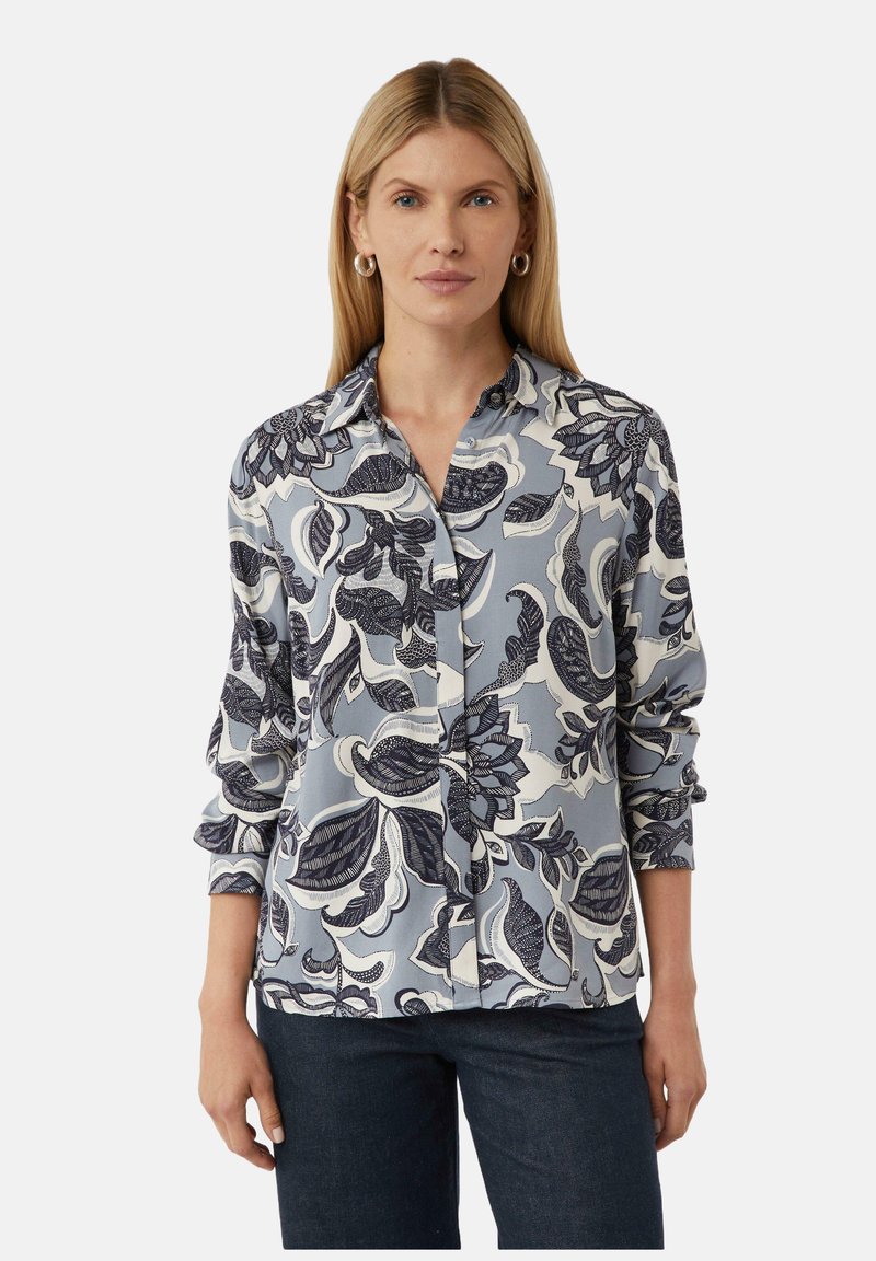 Bluse mit blauem Blumenmuster, Kragen, Knopfleiste und langen Ärmeln. Gefertigt aus einem glatten, weichen Stoff und mit filigranen Blattmustern.