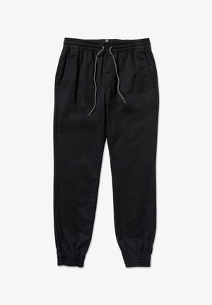 Pantalones jogger negros con cintura elástica y puños, cordones grises y bolsillos laterales, extendidos sobre un fondo blanco.
