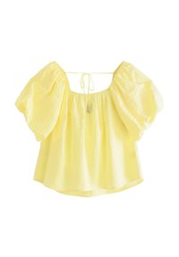 Gul puffärmad blus med en samlad halsringning och knytning i ryggen. Lättviktig tyg med en strukturerad yta och flödande silhuett.