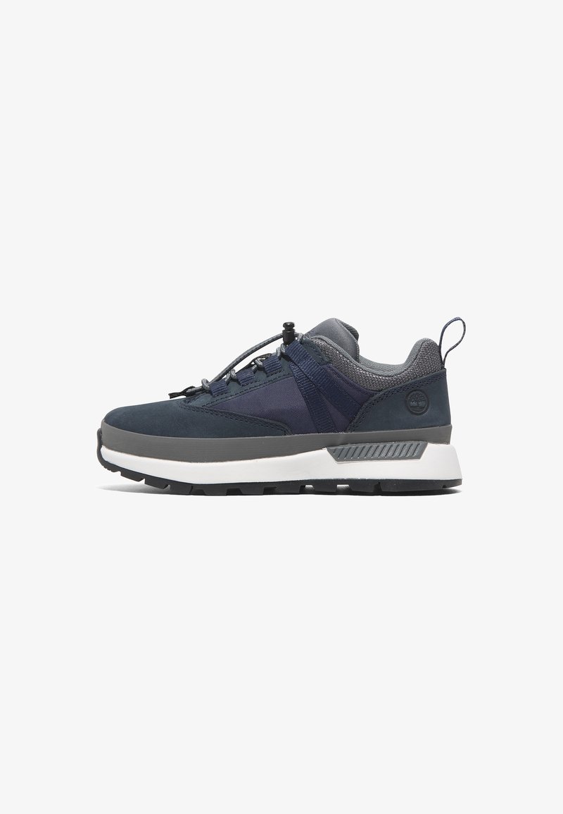 Navy and gray low-top sneaker with white sole, cushioned collar, secure toggle lacing, and textured grip outsole, side view on white background.