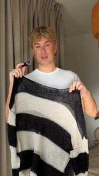 Sweater leve, em malha, com riscas bold em preto e branco, com um corte solto e textura de trama aberta. Acentuado com uma etiqueta.