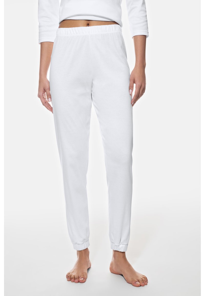 Pantalones deportivos blancos de algodón con cintura elástica y puños elásticos, con una textura suave y un diseño de pierna cónica.