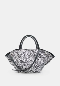 Borsa a tracolla bianca e nera a pois con manici neri arrotondati e una lunga tracolla nera regolabile.