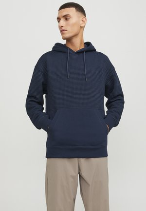 Navy hoodie with a textured upper section, kangaroo pocket, and adjustable drawstring hood. Soft fabric with a relaxed fit.