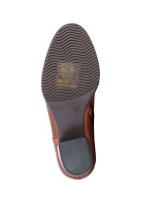 Brown leather shoe sole with textured grip, curved shape, and visible size marking. Includes care and manufacturing symbols printed on it.