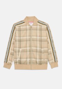Giacca beige a quadri con zip, colletto e polsini a coste. Presenta il marchio HUGO con strisce verdi e gialle lungo le maniche. Due tasche laterali.