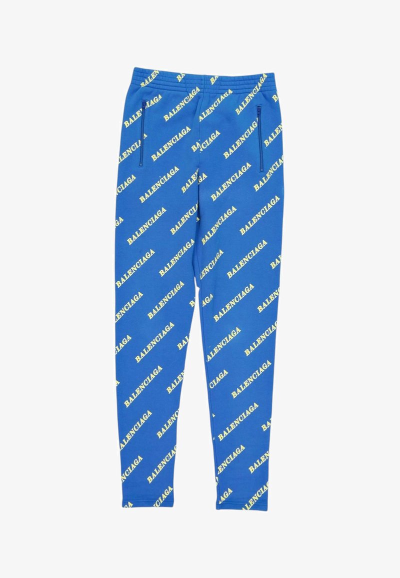 Leggings bleus avec logos jaunes Balenciaga répétés imprimés en diagonale et poches zippées à l'avant.