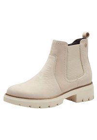 Botte de cheville en cuir beige avec des panneaux latéraux élastiques, bout rond et une semelle blanche épaisse dotée d'un motif texturé pour une meilleure adhérence.