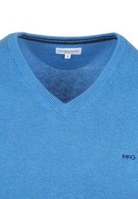 Light blue V-neck sweater made of soft knit fabric. Features a ribbed neckline and a small logo on the left side. Smooth texture.