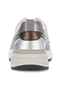 White and bronze athletic sneaker viewed from the back, featuring a loop pull tab, textured upper, and thick cushioned sole with black outsole.