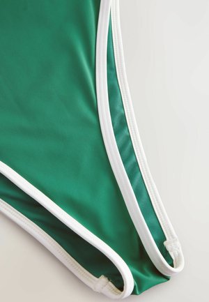 Groene zwemkleding met een slank ontwerp en witte details. Glad stofoppervlak, met een lage beenopening en versterkte stiksels.