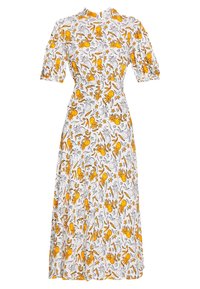 Robe midi blanche avec imprimé ananas et feuilles jaunes et noires, manches courtes bouffantes, col haut et taille ajustée.