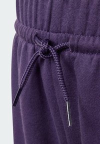 Lila bomullsjoggers med en texturerad yta, som har en elastisk midja och flätad dragsko med metalliska aglets.