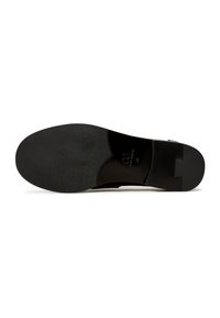 Black leather shoe sole with textured grip pattern, flat design, and slight arch. Features embossed branding near the heel.