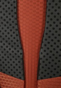 Textured fabric sections in black mesh and rust-orange hexagonal pattern. Features curved edges and visible stitching accents.