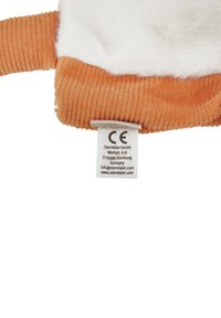 Fleece and corduroy plush accessory in orange and white, featuring a care label with CE marking and brand information.