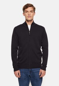 Svart zip-up cardigan tillverkad av mjuk stretchig väv, med hög krage, ribbade ärmslut och midja. Enkelt mönster utan dekorationer.