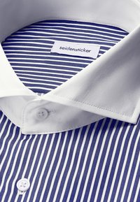 Blå og hvid vertikalt stribet skjorte med hvid krave og knapper, med et "seidensticker" label indeni kraven.