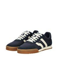 Sneaker blu navy con tomaia in suede e tessuto, caratterizzate da strisce crema, lacci bianchi e suola in gomma.