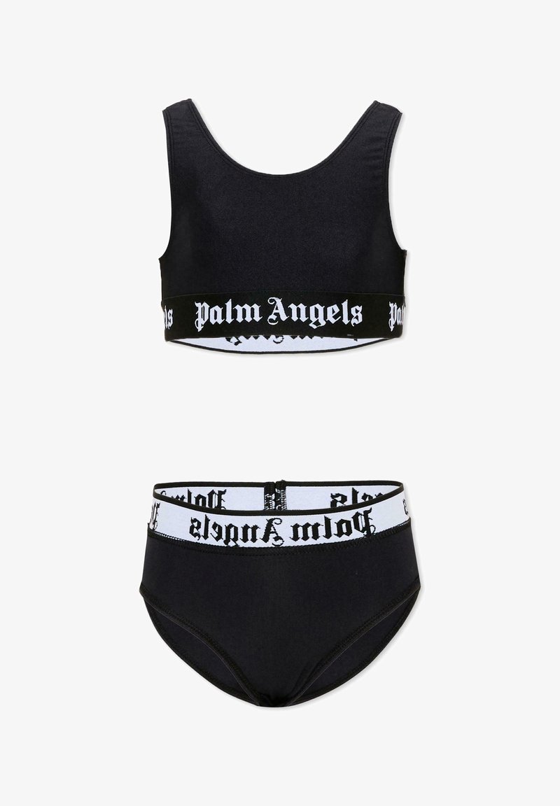 Ensemble soutien-gorge de sport noir et culottes taille haute avec bandes élastiques blanches affichant le logo texte gothique "Palm Angels".