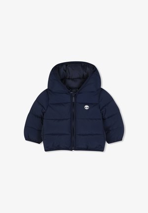 Veste matelassée bleu marine pour tout-petit avec capuche, fermeture éclair devant, poignets élastiques et petit logo blanc en forme d'arbre sur la poitrine gauche.