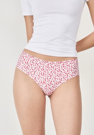 Slip di cotone bianco con motivo a cuori rosa, caratterizzato da una morbida cintura elastica e un taglio classico. Tessuto morbido per un comfort ottimale.