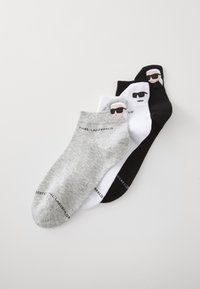 Three pairs of ankle socks: gray, white, and black. Each features a graphic of a person with sunglasses, branded with "Karl Lagerfeld."