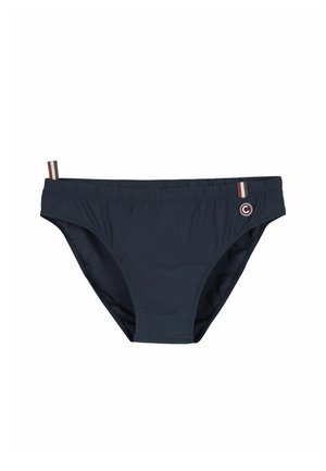 Tumesinised meeste ujumispüksid elastse vöökoha ja väikeste kangast aasadega, millel on punased, valged ja beežid triibud ning ümmargune logomärk.