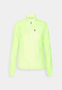 Veste légère jaune néon avec un col montant, une fermeture éclair complète à l'avant et des accents réfléchissants. Fabriquée en matériau lisse et résistant à l'eau.