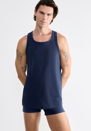 Navy blue cotton tank top with a crew neckline, paired with matching shorts. Features a straight cut and subtle logo detail on the hem.