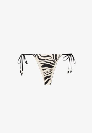 Sort-hvid zebra print bikini underdel med tynde snøre på begge sider, hver med små sorte perledetaljer for enden.